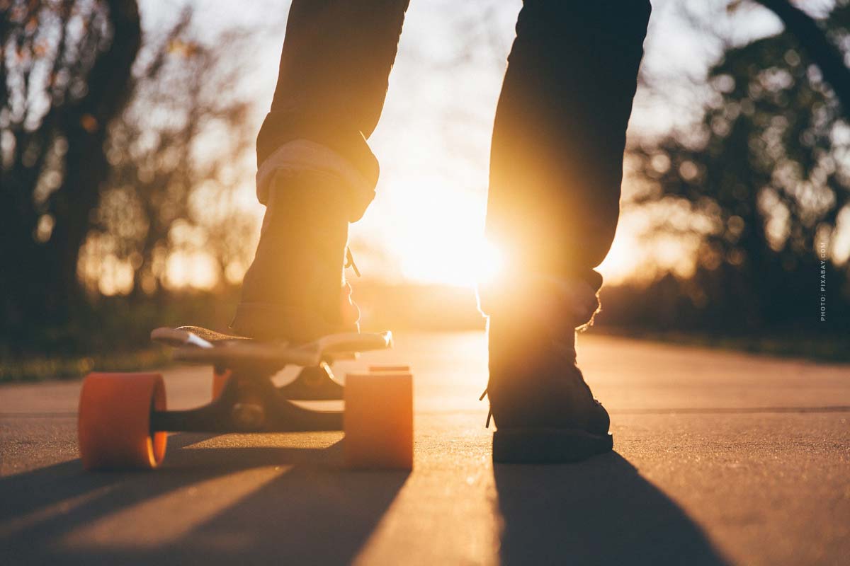 skateboard-boy-sun-shoes-sky-jeans-yellow-trees-street
